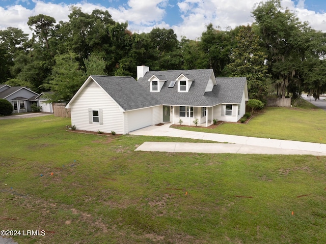 cape cod house featuring a garage and a front yard