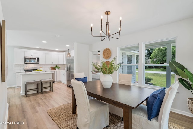 dining area featuring a chandelier and light wood-type flooring