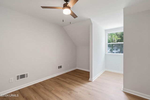 additional living space featuring lofted ceiling, light hardwood / wood-style flooring, and ceiling fan