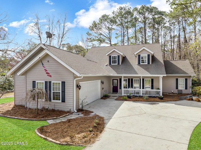 cape cod house featuring covered porch, a garage, a shingled roof, concrete driveway, and a front yard