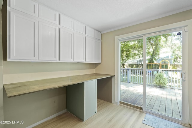 174 James St, Beaufort, SC 29902 - unfurnished office featuring light wood-style flooring, built in study area, and a textured ceiling