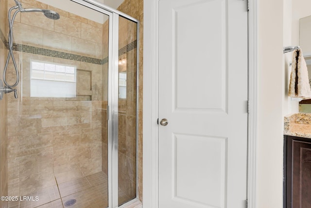 full bathroom with a shower stall and vanity