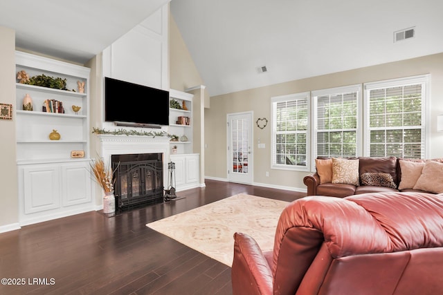 living room featuring visible vents, a fireplace with flush hearth, dark wood finished floors, and baseboards