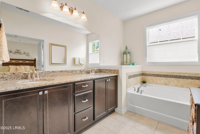 full bath featuring visible vents, a sink, a garden tub, and tile patterned floors