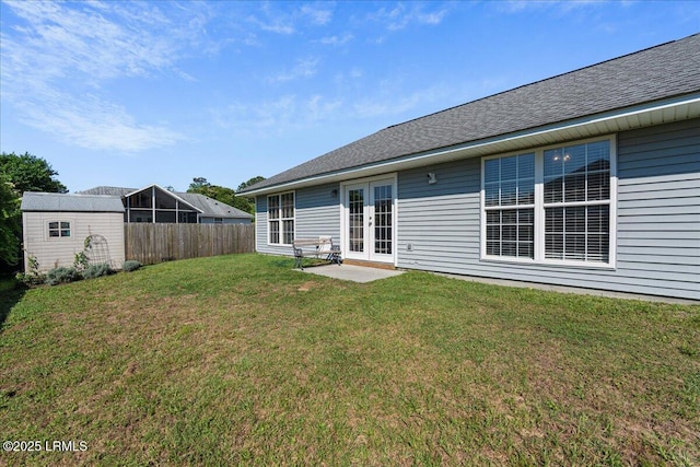 rear view of house featuring french doors, a storage shed, an outbuilding, and a shingled roof