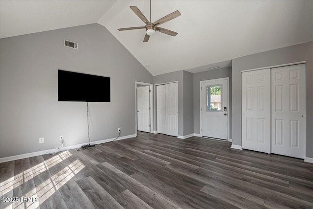 unfurnished living room with ceiling fan, dark wood-style floors, baseboards, and high vaulted ceiling