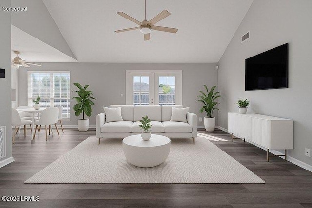 living room featuring ceiling fan, healthy amount of natural light, baseboards, and high vaulted ceiling