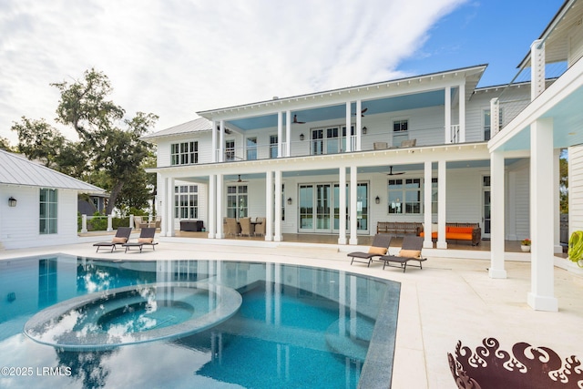 70 Brams Point Rd, Hilton Head Island, SC 29926 - rear view of house featuring a balcony, a ceiling fan, a patio, and a pool with connected hot tub