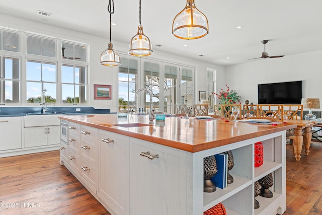 70 Brams Point Rd, Hilton Head Island, SC 29926 - kitchen with open shelves, a sink, butcher block countertops, white cabinetry, and a ceiling fan