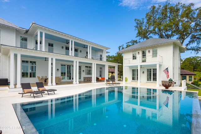 70 Brams Point Rd, Hilton Head Island, SC 29926 - rear view of property featuring a balcony, a patio area, an outdoor pool, and ceiling fan