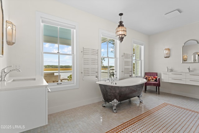 70 Brams Point Rd, Hilton Head Island, SC 29926 - full bath featuring vanity, a freestanding bath, and baseboards