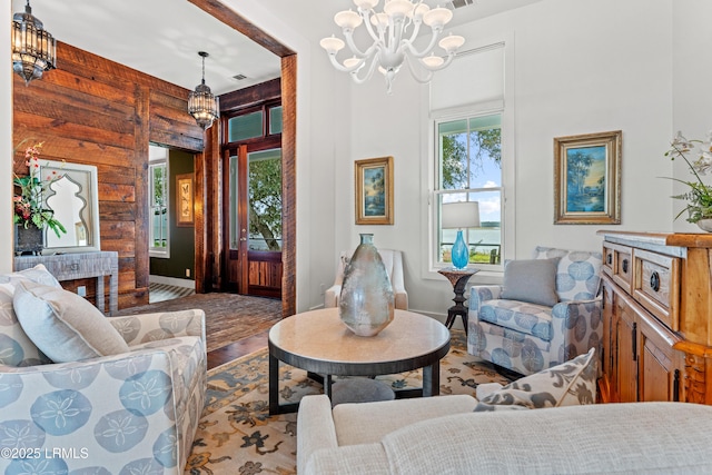 70 Brams Point Rd, Hilton Head Island, SC 29926 - living area with a chandelier, wood finished floors, wood walls, and baseboards