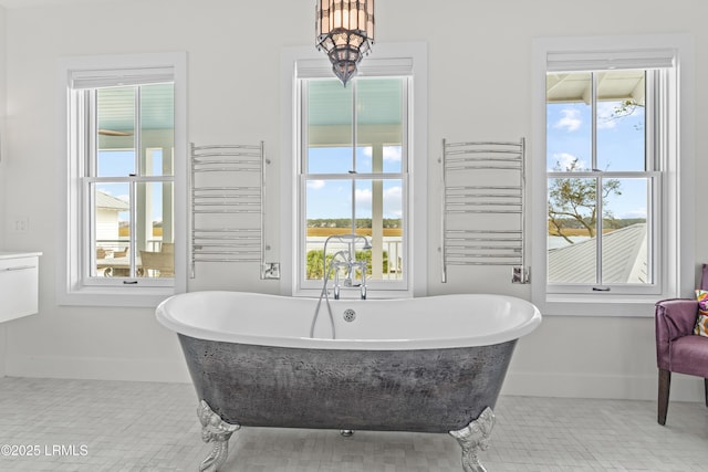 70 Brams Point Rd, Hilton Head Island, SC 29926 - bathroom with radiator heating unit, baseboards, and a freestanding bath