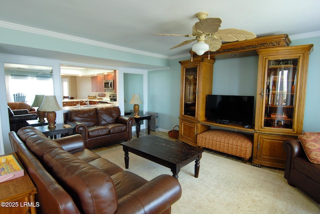living room with ornamental molding and ceiling fan