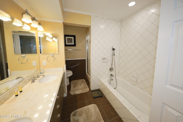 bathroom featuring vanity, ornamental molding, toilet, tile walls, and tile patterned floors