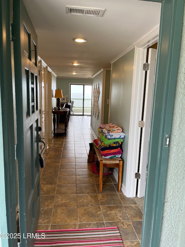 hallway featuring crown molding and visible vents