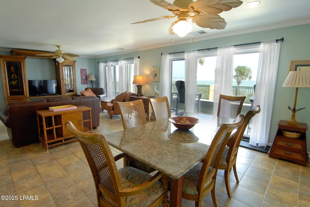 dining space featuring a ceiling fan, visible vents, and ornamental molding