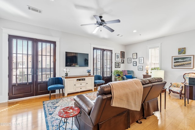 living area with ceiling fan, recessed lighting, visible vents, french doors, and light wood-type flooring