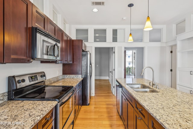 6 Abbey Row Unit 2A, Beaufort, SC 29906 - kitchen with a sink, stainless steel appliances, decorative light fixtures, light wood-type flooring, and visible vents