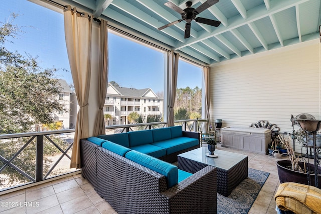 sunroom featuring ceiling fan and a wealth of natural light