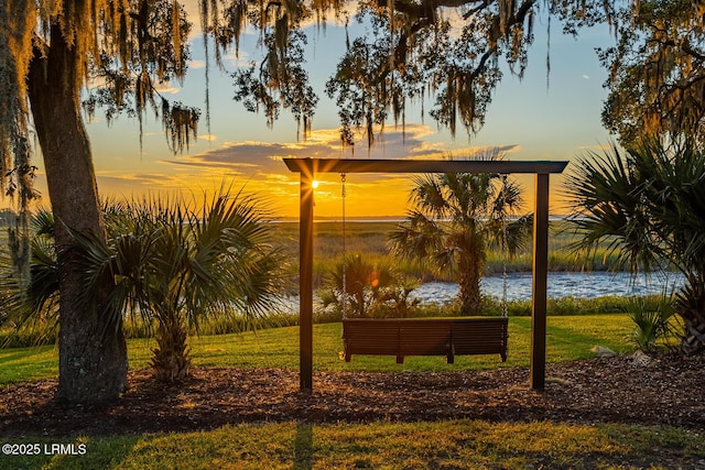 view of property's community with a yard and a water view