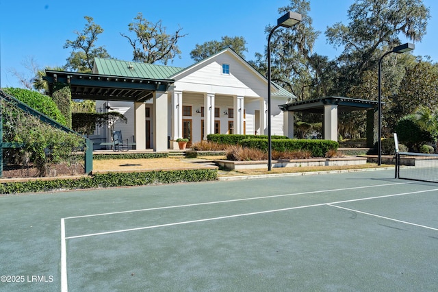 view of community featuring a tennis court