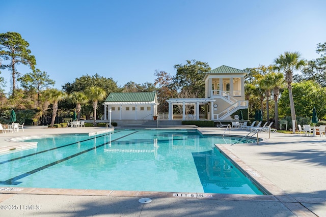 pool with a pergola and a patio