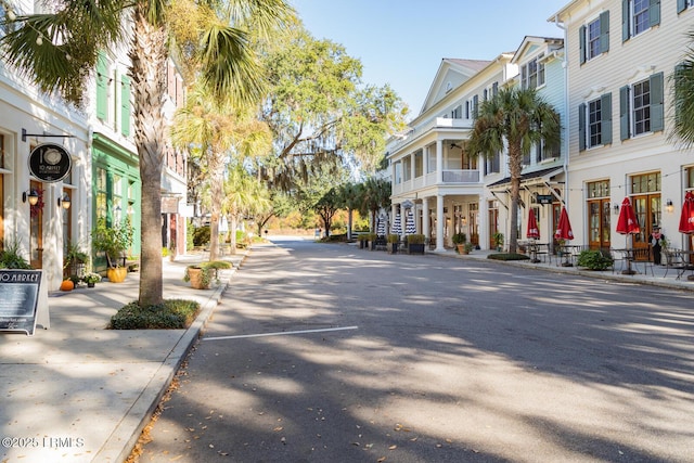 view of road with curbs, sidewalks, and a residential view