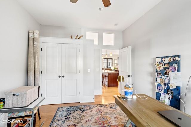 office space featuring ceiling fan and light wood finished floors