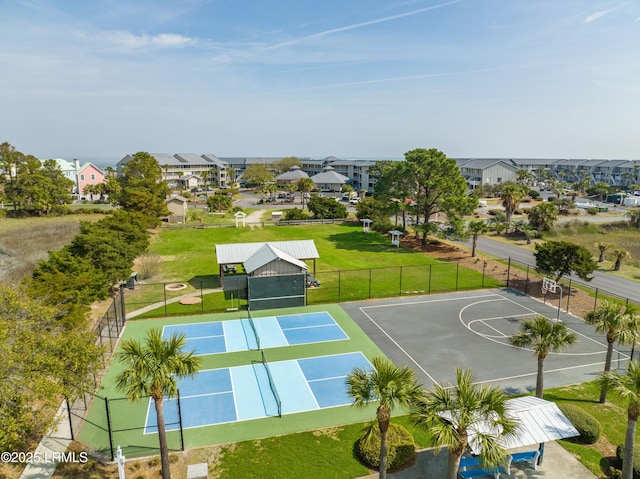 exterior space featuring a lawn, fence, community basketball court, and a tennis court