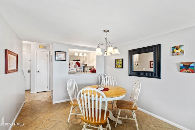 dining room with light tile patterned floors, baseboards, and an inviting chandelier