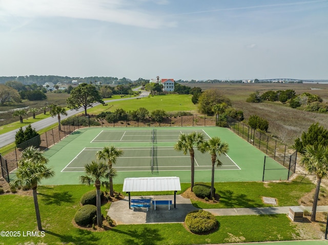 view of sport court featuring a lawn and fence