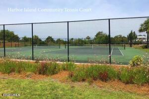 view of tennis court featuring fence