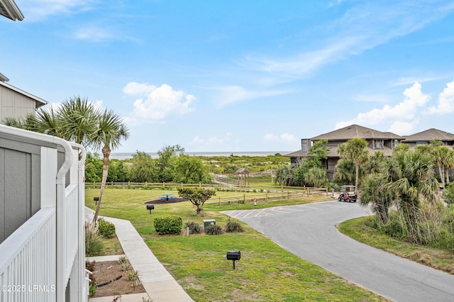 view of property's community featuring fence and a yard