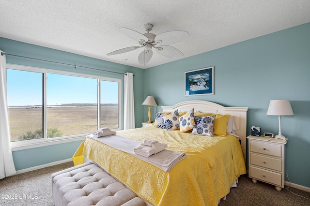bedroom featuring baseboards, carpet flooring, and a textured ceiling
