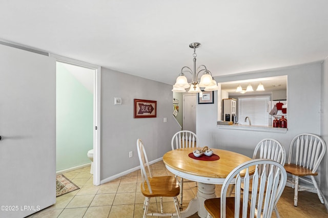 dining space featuring baseboards, light tile patterned floors, and a notable chandelier