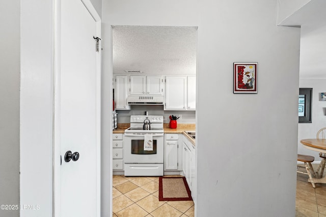 kitchen featuring exhaust hood, light countertops, white range with electric cooktop, white cabinetry, and light tile patterned floors