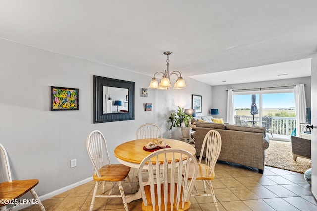 dining room featuring baseboards, a chandelier, and light tile patterned flooring