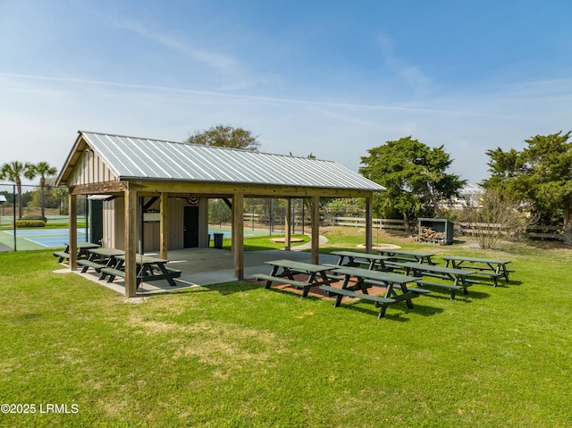 view of property's community featuring fence and a yard
