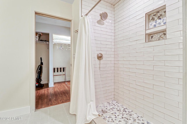 bathroom featuring curtained shower and tile patterned floors