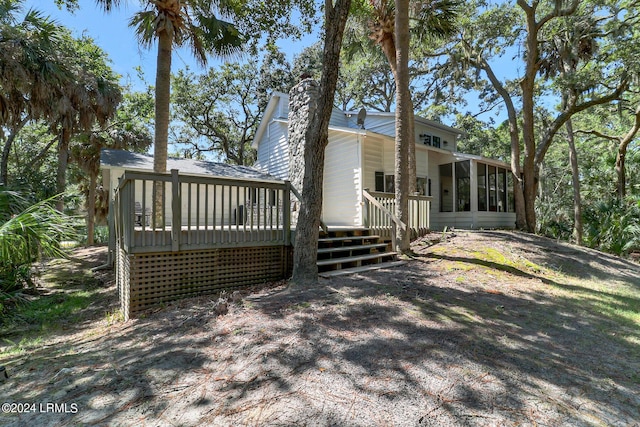 exterior space featuring a sunroom and a deck