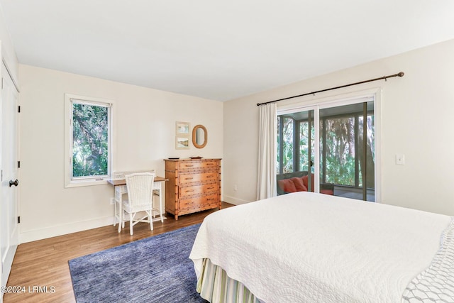 bedroom featuring dark hardwood / wood-style floors and access to outside