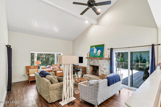 living room with a stone fireplace, plenty of natural light, high vaulted ceiling, and dark hardwood / wood-style flooring