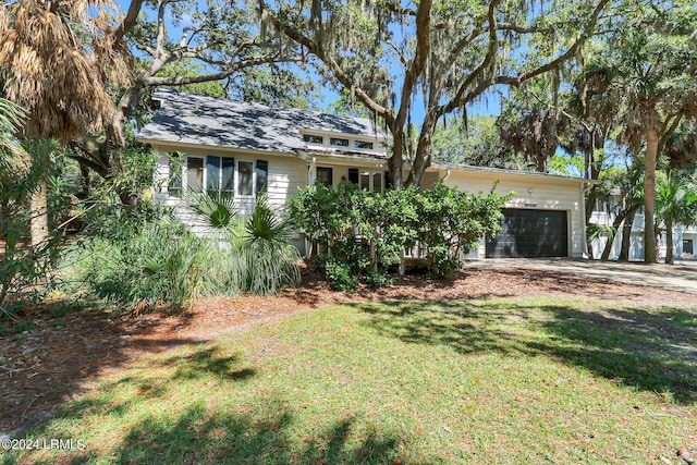 view of front of property with a garage and a front yard