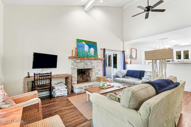 living room featuring a stone fireplace, wood-type flooring, high vaulted ceiling, beam ceiling, and ceiling fan with notable chandelier