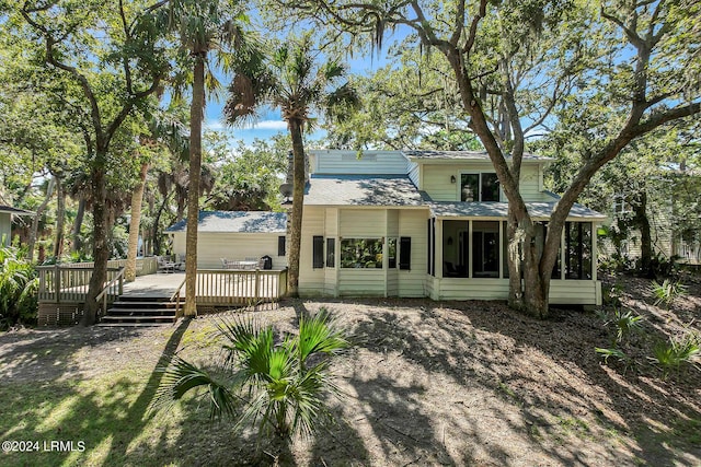 rear view of house featuring a deck and a sunroom