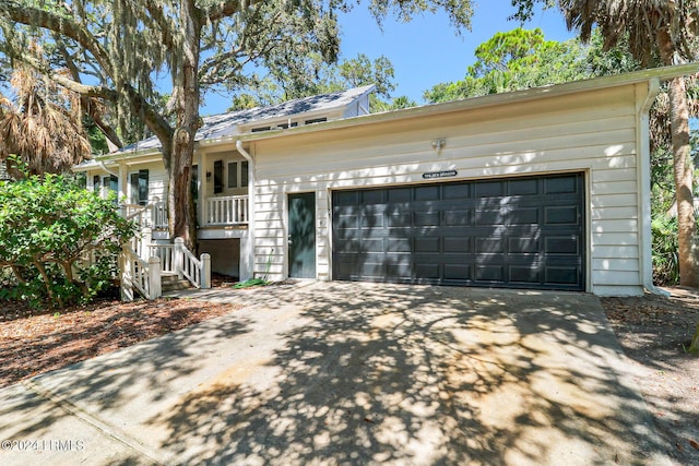 ranch-style house featuring a garage and covered porch