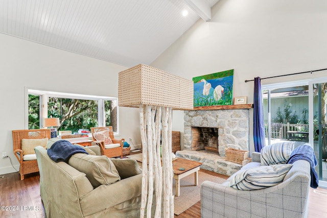 living room with a stone fireplace, high vaulted ceiling, beamed ceiling, and hardwood / wood-style flooring