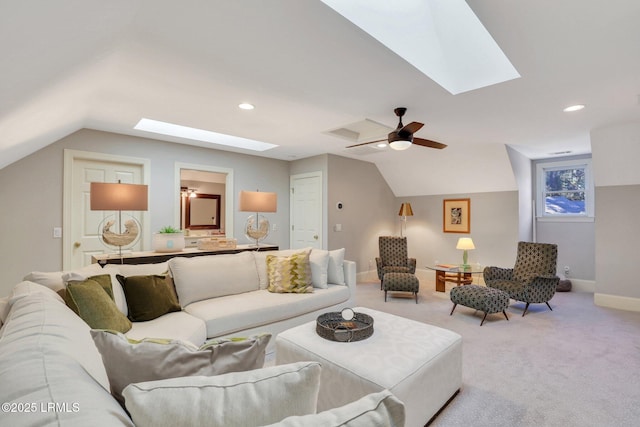 carpeted living room featuring ceiling fan and vaulted ceiling with skylight