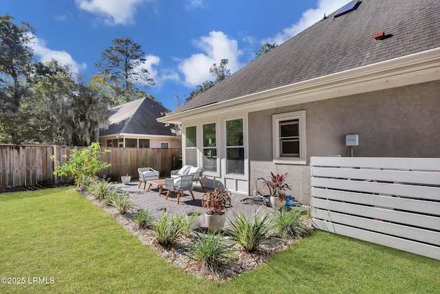 rear view of property with a lawn and a patio